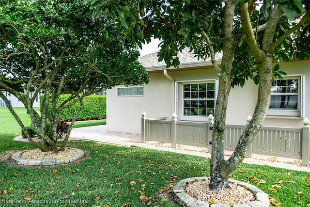 view of side of home with a lawn