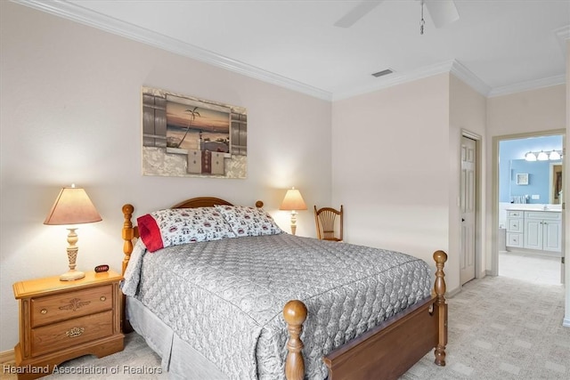 carpeted bedroom with ensuite bathroom, ceiling fan, and crown molding