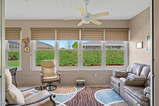 sunroom / solarium featuring ceiling fan