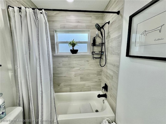 bathroom with toilet and shower / bath combo with shower curtain