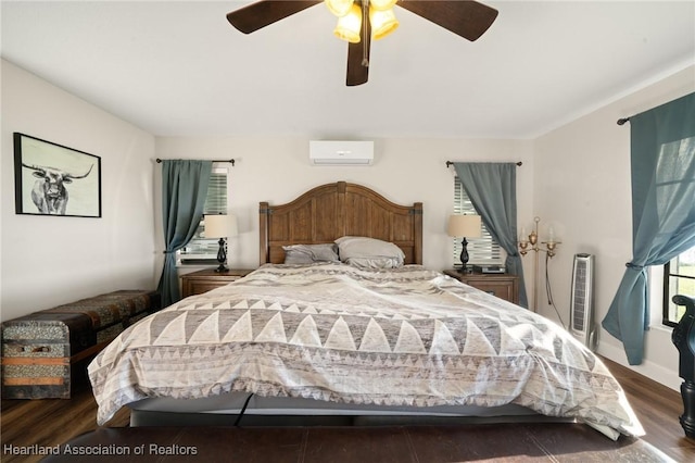 bedroom with a wall unit AC, wood finished floors, and a ceiling fan