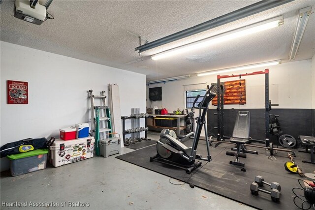 workout area with a garage and a textured ceiling