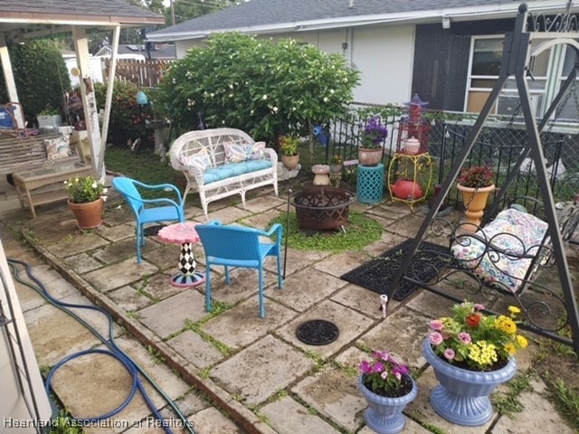 view of patio / terrace featuring an outdoor fire pit