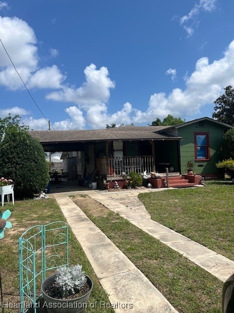 410 Walnut St, Sebring, FL 33870 - single story home featuring a front lawn and covered porch
