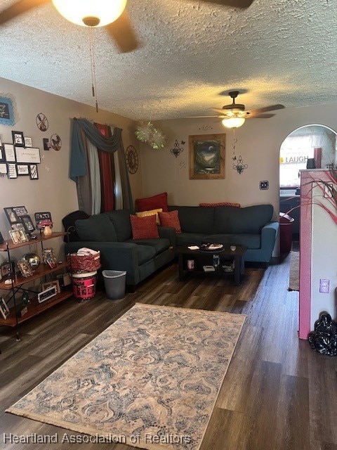410 Walnut St, Sebring, FL 33870 - living room featuring dark wood-style flooring, ceiling fan, and a textured ceiling