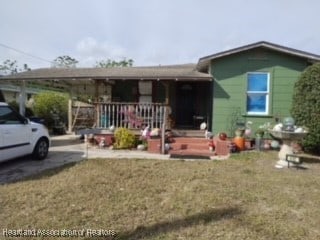 view of front of house featuring a front lawn and a porch