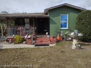 view of front of property with a front yard and a porch