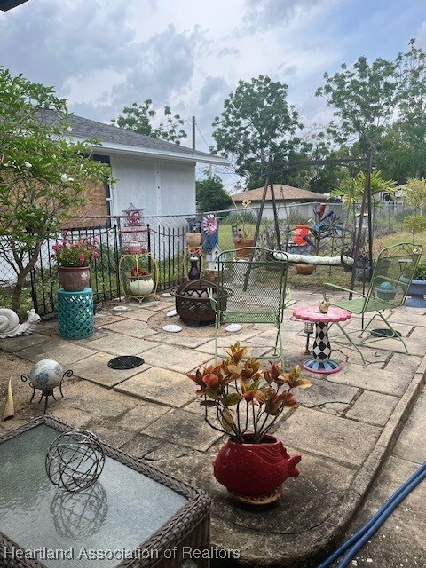 410 Walnut St, Sebring, FL 33870 - view of patio / terrace with an outdoor fire pit