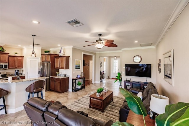 living room featuring ornamental molding, light tile patterned floors, and ceiling fan