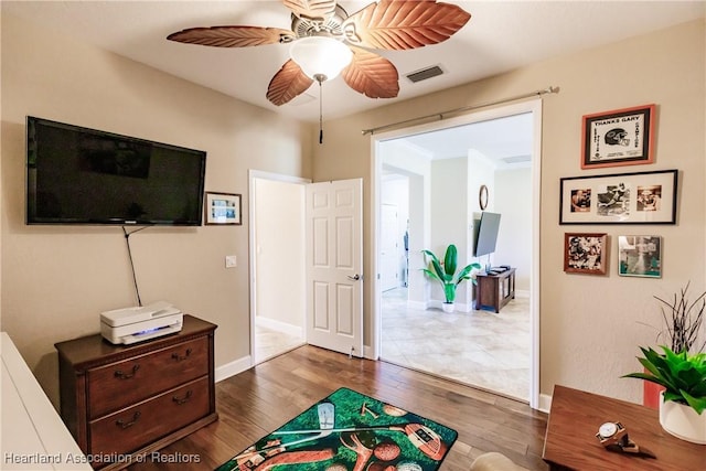 interior space featuring ceiling fan and dark hardwood / wood-style flooring