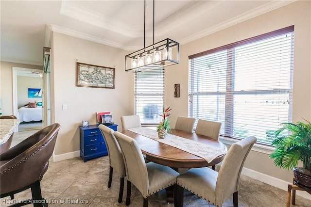 dining area featuring crown molding, a tray ceiling, and a wealth of natural light