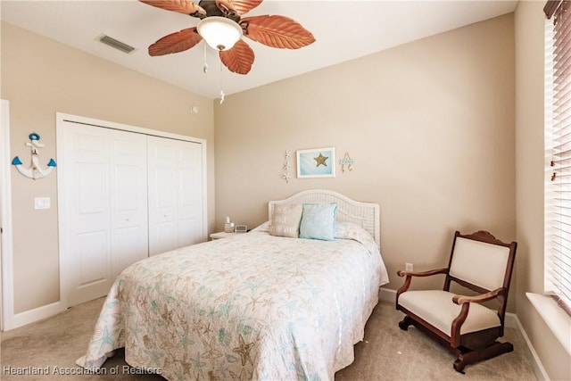 carpeted bedroom featuring ceiling fan and a closet