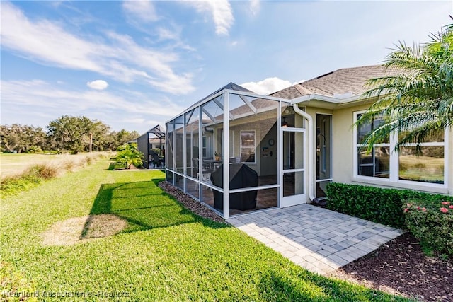 back of house with a lawn and a patio area