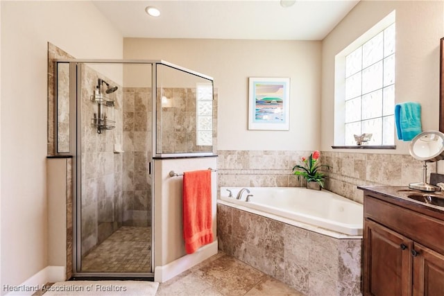 bathroom featuring vanity, tile patterned floors, and plus walk in shower