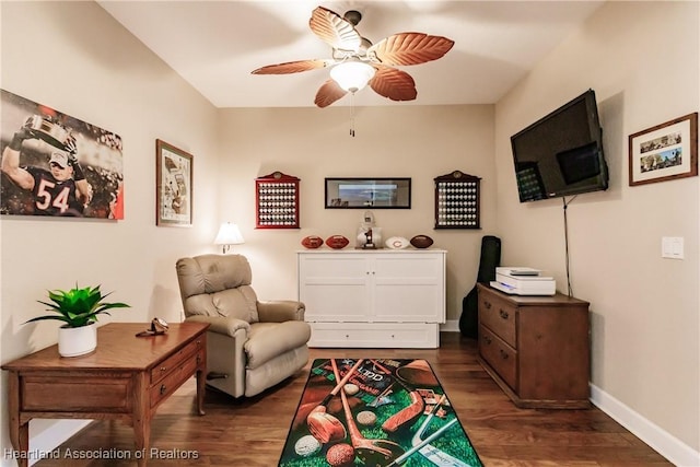 living area with dark hardwood / wood-style flooring and ceiling fan