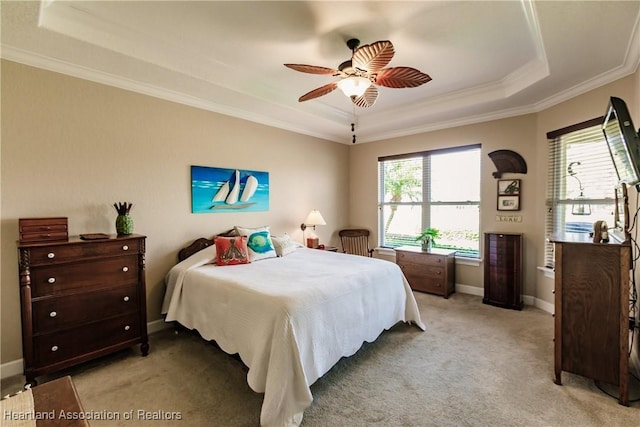 bedroom featuring crown molding, light colored carpet, a raised ceiling, and ceiling fan