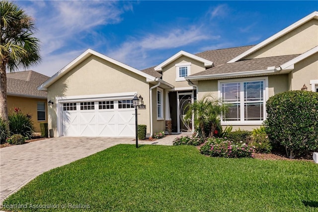 ranch-style home featuring a garage and a front yard