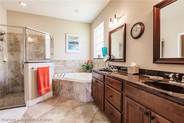 bathroom with tile patterned floors, vanity, and separate shower and tub