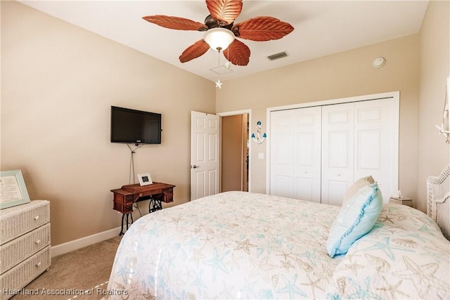 bedroom with light colored carpet, ceiling fan, and a closet