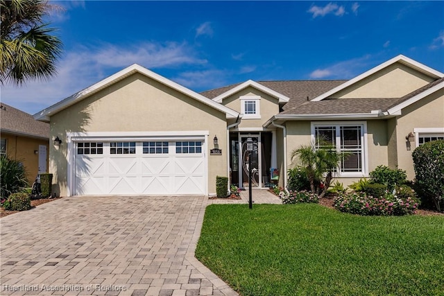 view of front of house with a garage and a front yard