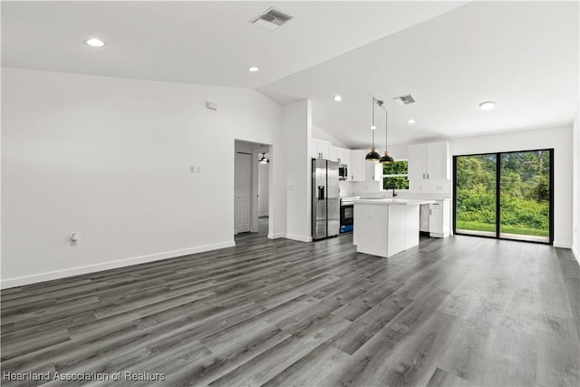 1502 Oak Ave, Lake Placid, FL 33852 - unfurnished living room with recessed lighting, baseboards, dark wood-style flooring, lofted ceiling, and a sink