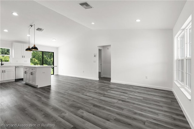 1502 Oak Ave, Lake Placid, FL 33852 - unfurnished living room with plenty of natural light, vaulted ceiling, baseboards, recessed lighting, and dark wood-type flooring