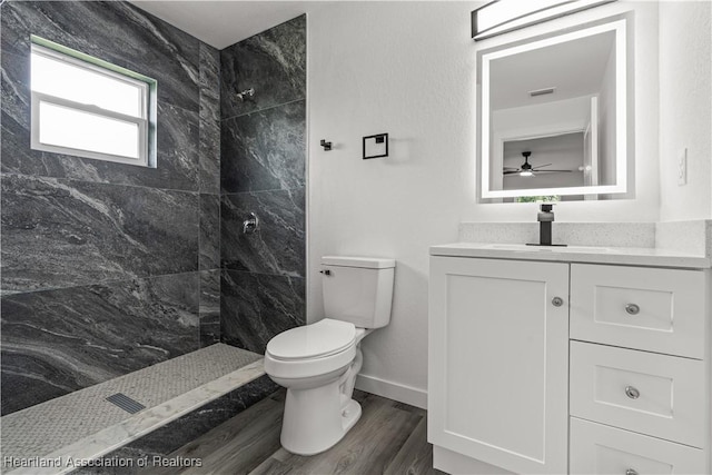 1502 Oak Ave, Lake Placid, FL 33852 - full bath with toilet, tiled shower, vanity, wood finished floors, and ceiling fan