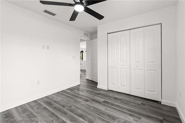 1502 Oak Ave, Lake Placid, FL 33852 - unfurnished bedroom featuring wood finished floors, baseboards, a closet, and ceiling fan