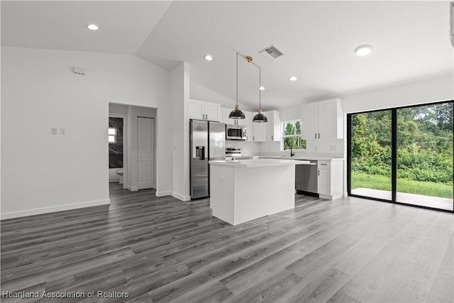 1502 Oak Ave, Lake Placid, FL 33852 - kitchen featuring stainless steel appliances, a kitchen island, light countertops, white cabinets, and lofted ceiling