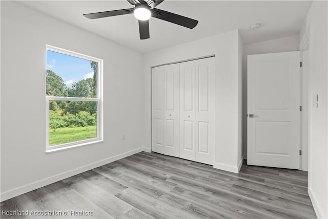 1502 Oak Ave, Lake Placid, FL 33852 - unfurnished bedroom featuring baseboards, light wood-type flooring, a closet, and a ceiling fan