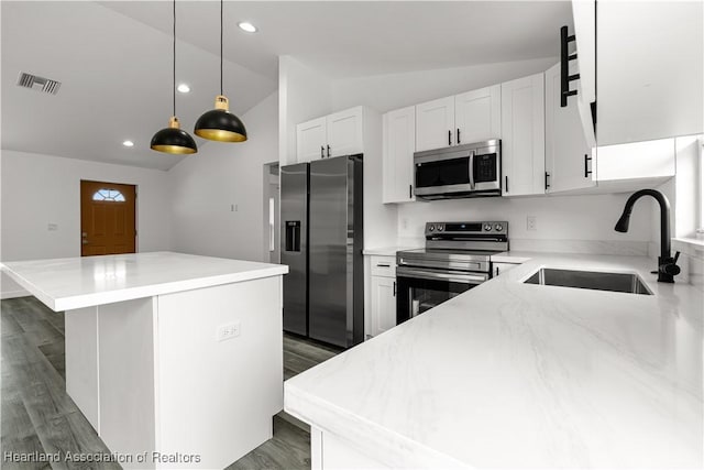 1502 Oak Ave, Lake Placid, FL 33852 - kitchen featuring appliances with stainless steel finishes, a sink, vaulted ceiling, a center island, and dark wood-style floors