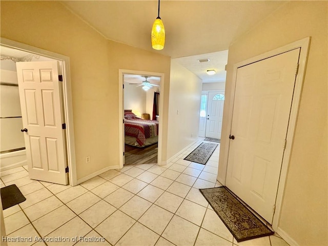 interior space featuring light tile patterned flooring and baseboards