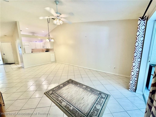 living area with light tile patterned floors, baseboards, a ceiling fan, and vaulted ceiling