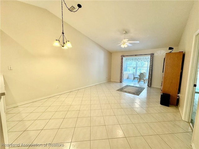 unfurnished room with vaulted ceiling, light tile patterned flooring, ceiling fan with notable chandelier, and baseboards