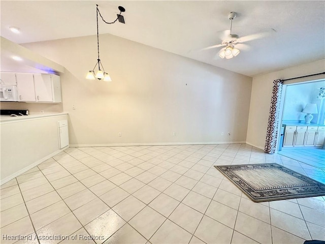 interior space with light tile patterned flooring, ceiling fan with notable chandelier, baseboards, and lofted ceiling