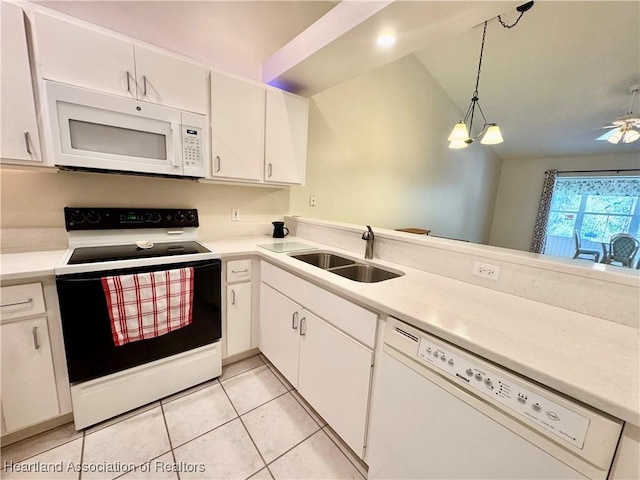 kitchen with a sink, white cabinetry, white appliances, light countertops, and light tile patterned floors