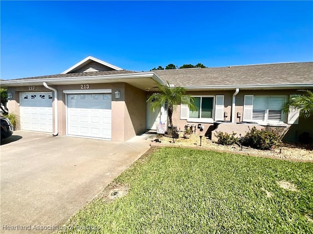 ranch-style home featuring stucco siding, roof with shingles, concrete driveway, a front yard, and a garage