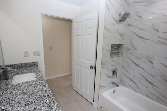 bathroom with vanity and tiled shower / bath