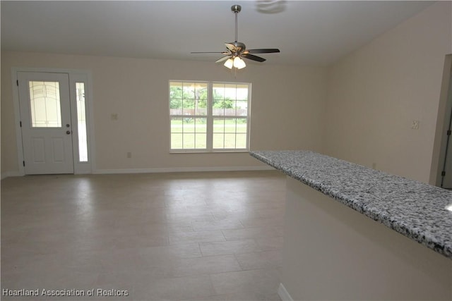 interior space featuring ceiling fan