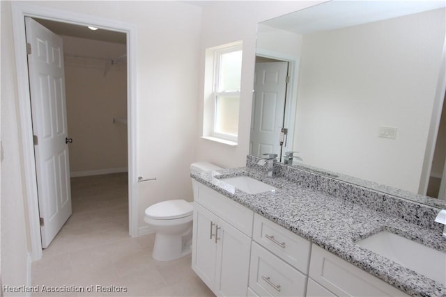 bathroom featuring tile patterned flooring, vanity, and toilet