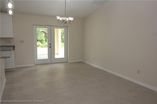 interior space with an inviting chandelier and french doors