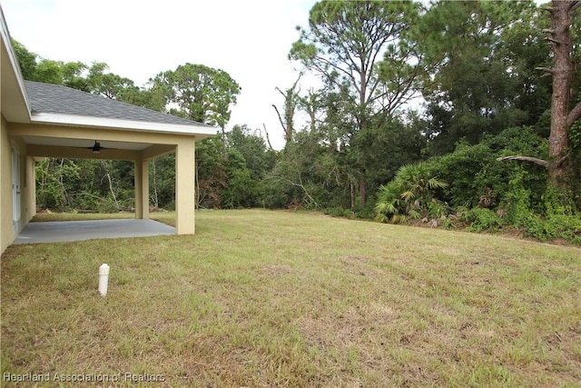 view of yard featuring ceiling fan and a patio area