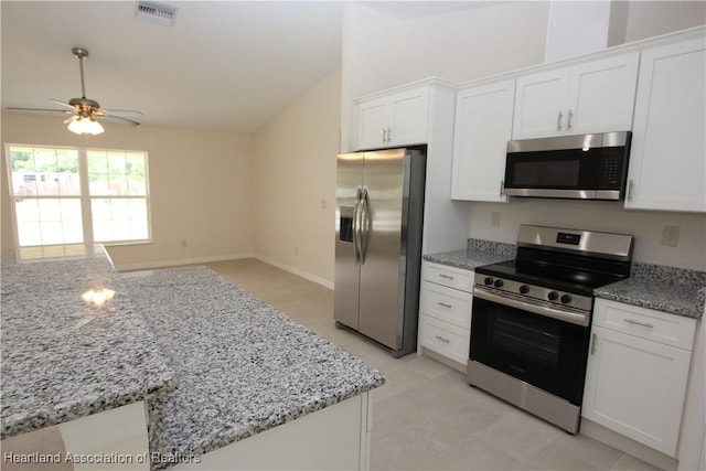 kitchen with ceiling fan, light stone counters, white cabinetry, and appliances with stainless steel finishes