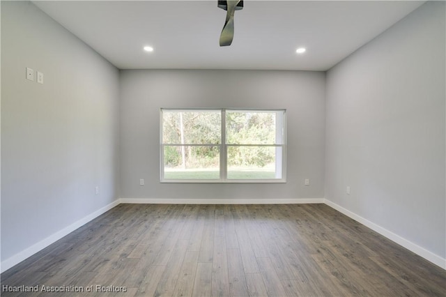 spare room with dark hardwood / wood-style flooring