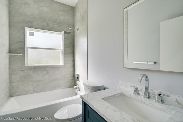 full bathroom featuring vanity, toilet, and tiled shower / bath