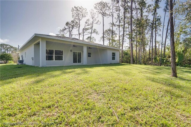 rear view of property with a yard