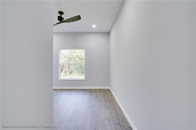 unfurnished room with wood-type flooring and ceiling fan