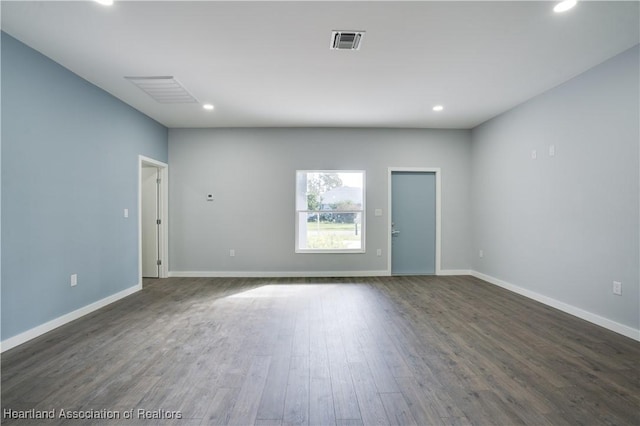 unfurnished room featuring dark wood-type flooring