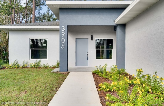 doorway to property featuring a yard