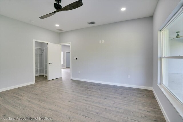 spare room with light hardwood / wood-style floors and ceiling fan